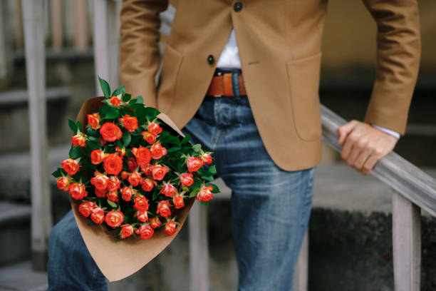istock A bouquet of roses in male hands. 865732330