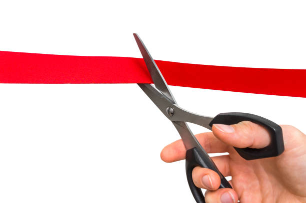 istock Hand with scissors cutting red ribbon - opening ceremony 865732774