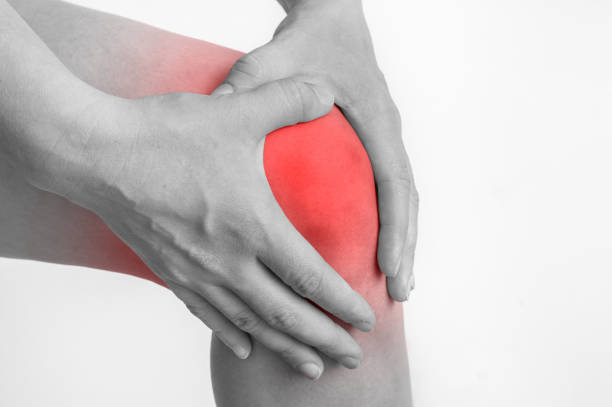istock Woman with knee pain is holding her aching leg 865733020