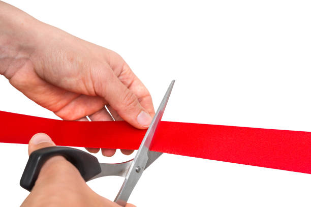 istock Hand with scissors cutting red ribbon - opening ceremony 865733936
