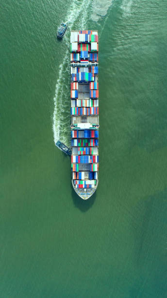 istock container,container ship in import export and business logistic,By crane,Trade Port , Shipping,cargo to harbor.Aerial view,Water transport,International,Shell Marine,transportation,logistic,trade,port 865734030