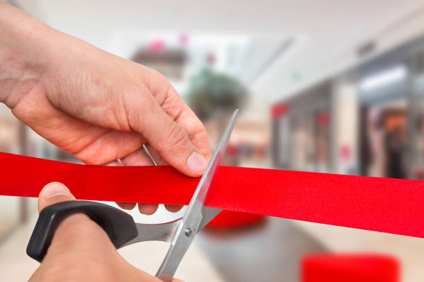 istock Hand with scissors cutting red ribbon - opening ceremony 865734224