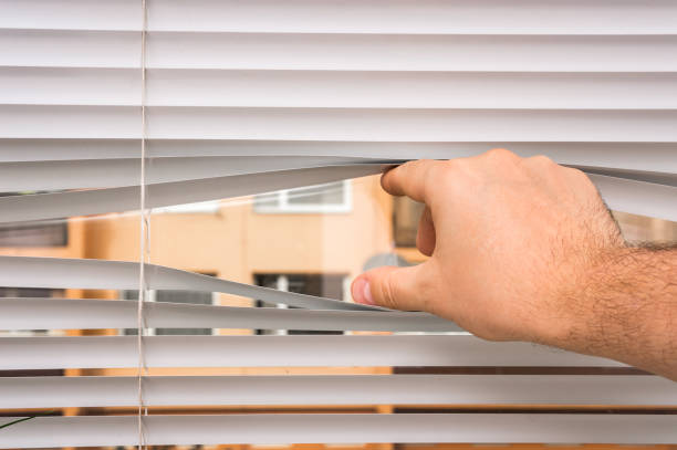 istock Man is looking out through jalousie 865734250