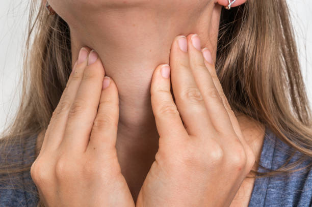 istock Woman with throat sore is holding her aching throat 865734540