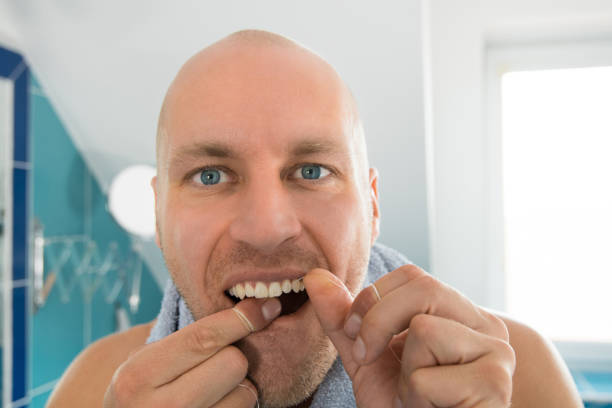 istock The man cleans his teeth in the bathroom. 865737628