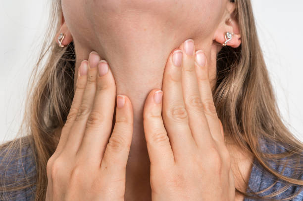 istock Woman with throat sore is holding her aching throat 865737770
