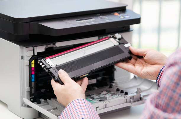 Man replacing toner in laser printer Man replacing toner in laser printer. toner printer cartridge print laser office supplies refill concept bullet cartridge photos stock pictures, royalty-free photos & images