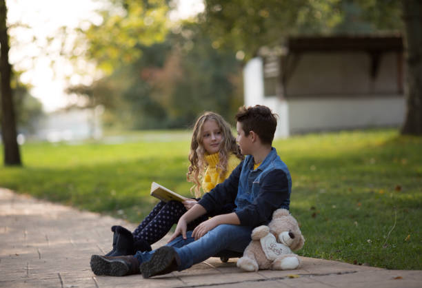 istock Boy and girl enjoying in park 865741430
