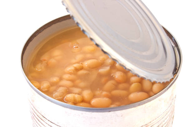 istock Open tin can of beans  on white background