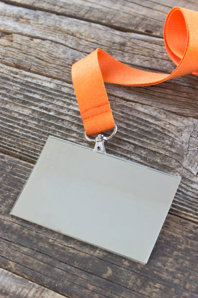 istock Blank ID card tag with ribbon on wooden background