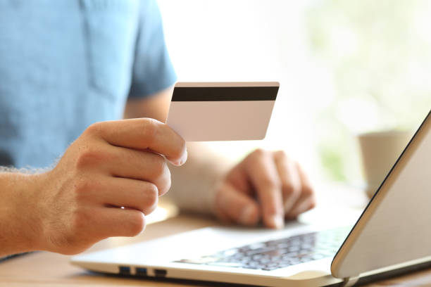 istock Man hand paying on line with credit card 865753682