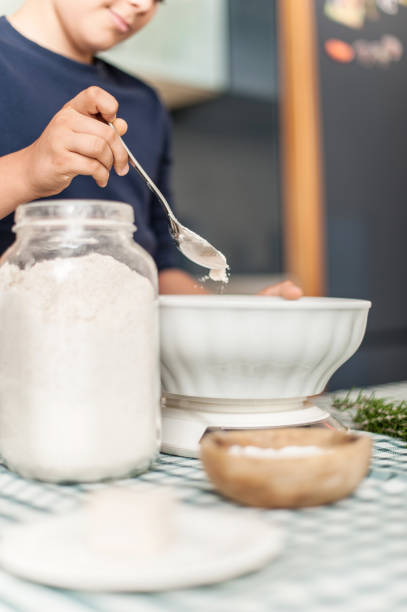 istock Teenage Boy Measuring Flour 865757076