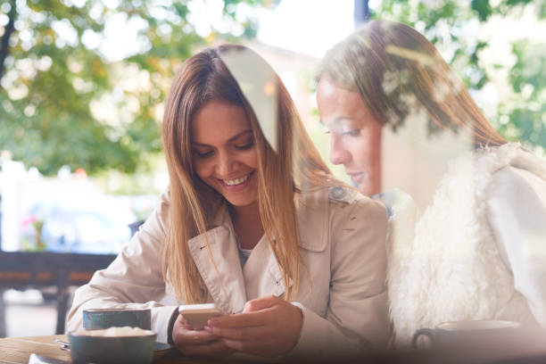 istock Happy women surfing net on smartphone 865757958