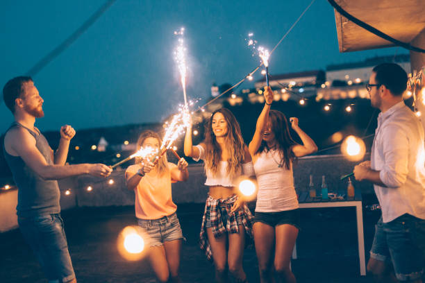 istock Group of happy friends celebrating at rooftop 865760264