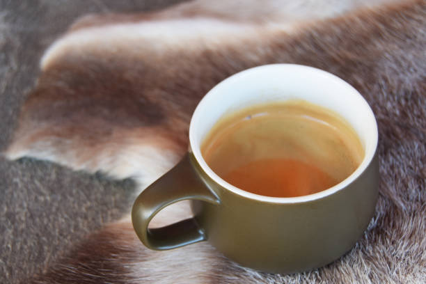 Coffee cup on reindeer skins stock photo