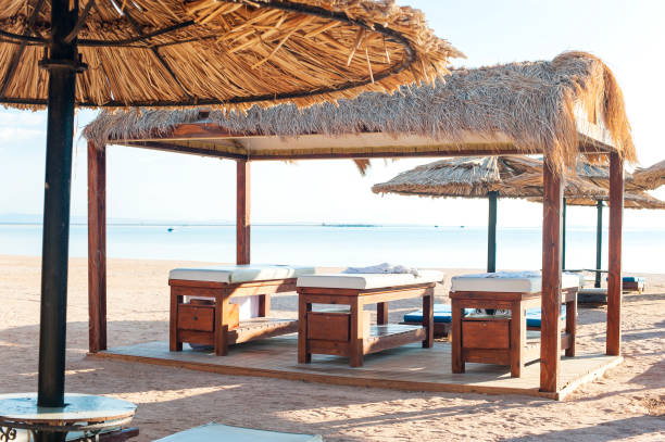 istock Thatched wooden authentic empty massage houses on tropical beach. 865764302