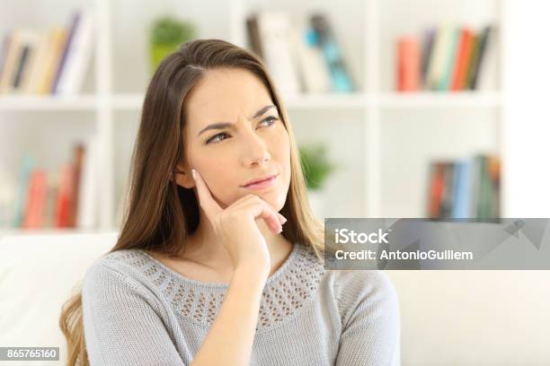 Woman Wondering Sitting At Home Stock Photo - Download Image Now - Women, One Woman Only, Contemplation