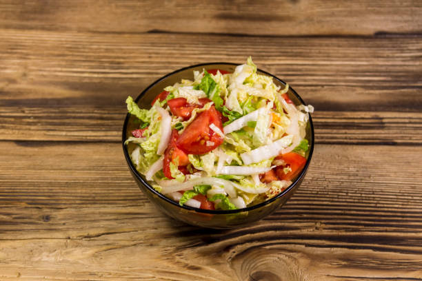 istock Fresh vegetable salad on wooden table 865767484