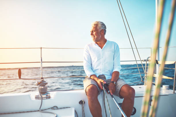 istock Mature man sailing his boat on the open ocean 865768386