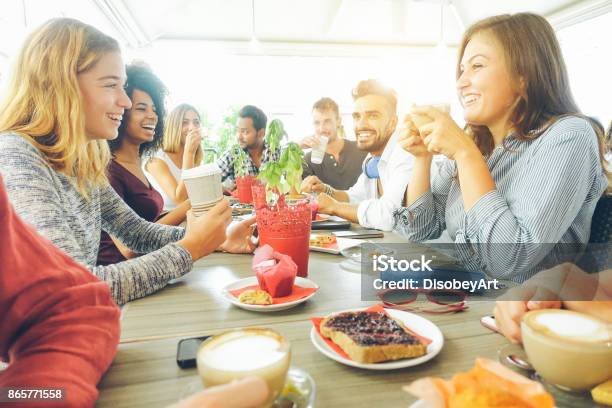 Happy Friends Having Coffee Break At Bar Cafe Young Hipster People Enjoying Breakfast Friendship And Good Mood Concept Focus On Right Woman Drinking Cappuccino Vsco Filter Stock Photo - Download Image Now