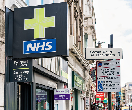 London, UK - A street in Southwark, London, with a NHS Pharmacy store in the foreground.