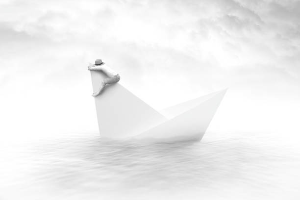 istock man clinging to a sinking paper boat surreal concept 865772090