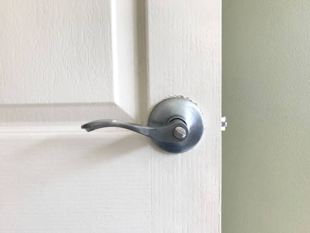 istock White open wooden door and green wall 865776314