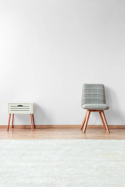 istock Grey chair near white nightstand 865776702