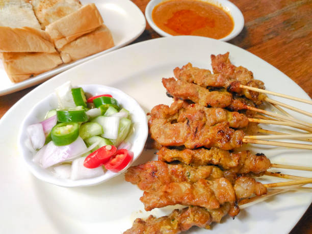 istock Beef satay with cucumber salad and peanut sauce 865777402