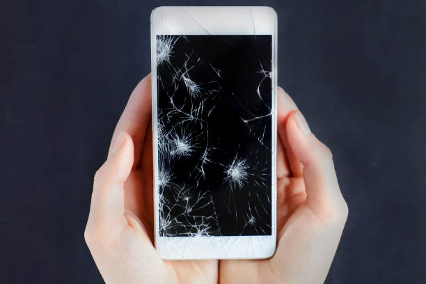 istock Girl holding a broken smart phone. 865780922