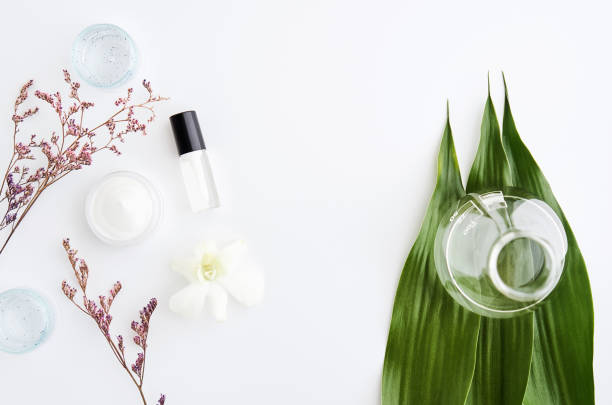 istock White cream bottle placed and flowers, Blank label package for mock up on a white background. The concept of natural beauty products. 865780974