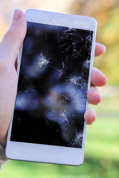 istock Girl holding a broken smart phone. 865781390