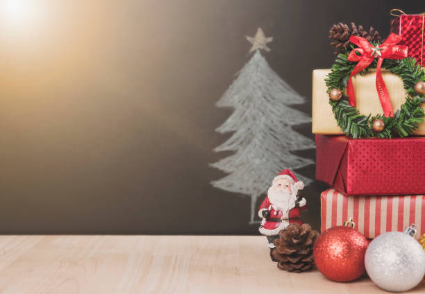 istock Christmas table with decorations and gift box on christmas tree background. 865786412