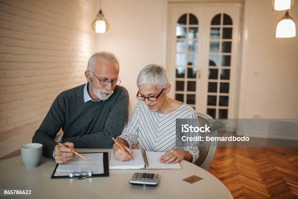 Eliminating Expenses One By One Stock Photo - Download Image Now - Pension, Planning, Senior Adult