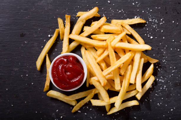 istock French fries with ketchup, top view 865791374