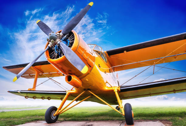 biplane biplane against a cloudy sky aerobatics photos stock pictures, royalty-free photos & images