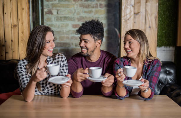 istock Young multi-ethnic group of people enjoying their coffee break 865796932