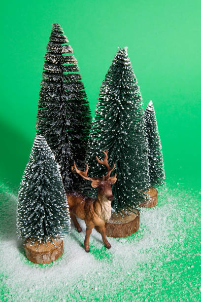 istock snowy forest firs and reindeer green 865800316