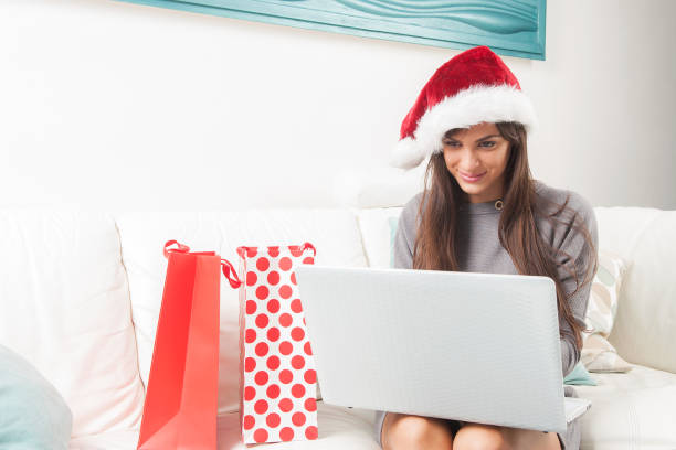 istock Lady making christmas on line shopping from home 865800374
