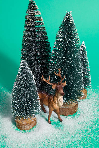 istock snowy forest firs and reindeer green 865800614