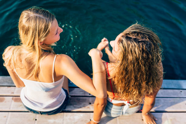 Women enjoy the sun on the pier