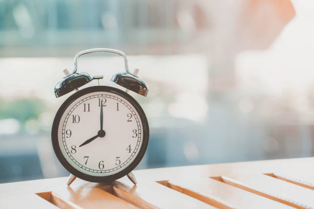 istock Retro alarm clock on wooden table, vintage style 865801134