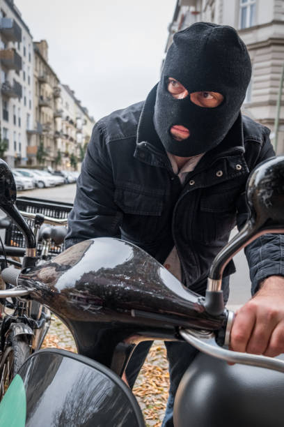 istock Theft wearing a balaclava stealing a scooter 865804868