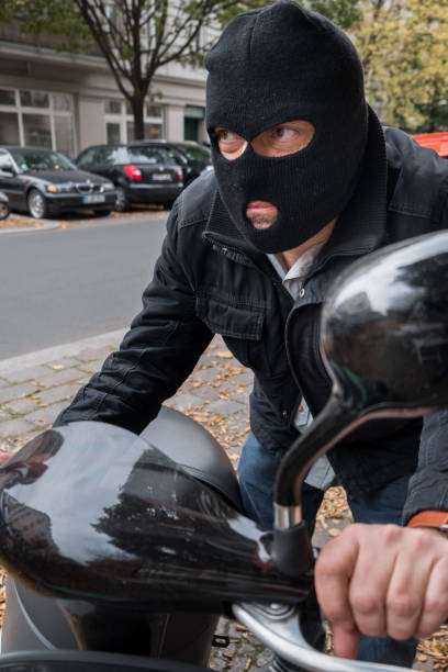 istock Theft wearing a balaclava stealing a scooter 865804878