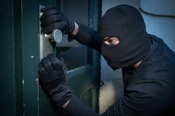 Photo of Burglar trying to force a door lock