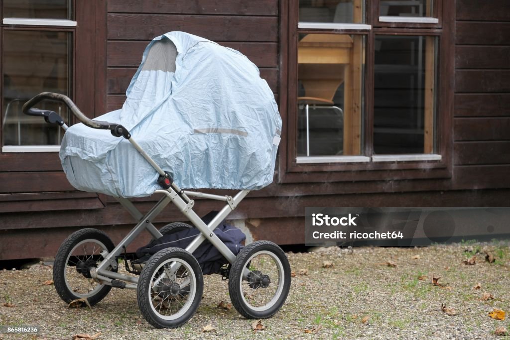 Baby taking a typical nap outside in a landau in Scandinavia, Denmark Baby - Human Age Stock Photo