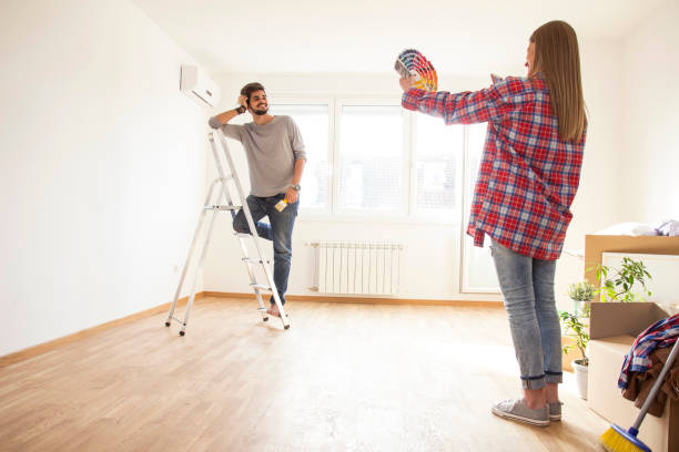 istock Young couple in new flat choosing colors for walls 865820428