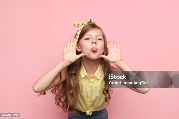 Girl Showing Tongue At Camera Stock Photo - Download Image Now - Child, Girls, Mischief