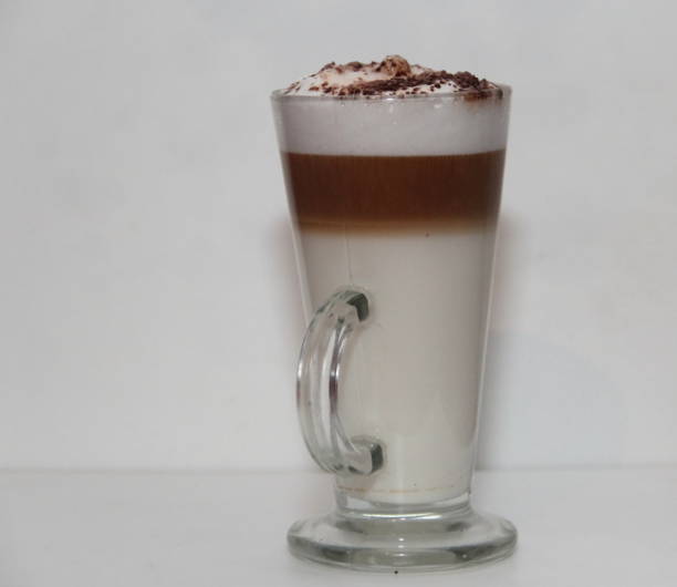 istock cappuccino in tall glass on white background 865821120