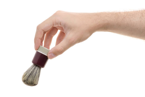 Shaving brush in a male hand on a white background isolation